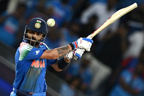 India's Virat Kohli hits the winning boundary and completes his century during the ICC Champions Trophy one-day international (ODI) cricket match against Pakistan at the Dubai International Stadium in Dubai on February 23.