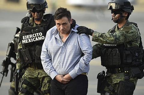 The alleged leader of the Zetas drug carteL, Oscar Omar Trevino, aka "Z-42" is taken under custody to be presented to the press at the Attorney General Office's hangar at the airport in Mexico City, on March 4, 2015.