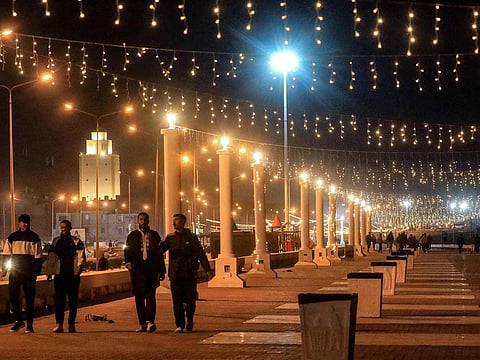 People walk along the decorated seaside corniche, in Libya's second-largest city of Benghazi.