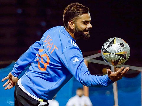 India's Virat Kohli plays football during a practice session ahead of the match against New Zealand in the ICC Champions Trophy, at Dubai International Cricket Stadium.