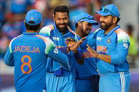 India's Hardik Pandya celebrates with teammates after taking the wicket of New Zealand's Rachin Ravindra in the Champions Trophy match at Dubai International Stadium on Sunday.