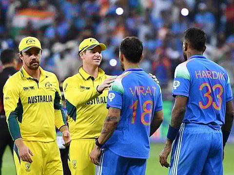 Australia's captain Steve Smith (2L) greets India's Virat Kohli as India's Hardik Pandya (R) watches at the end of the ICC Champions Trophy one-day international (ODI) semi-final cricket match at the Dubai International Stadium in Dubai on March 4, 2025.