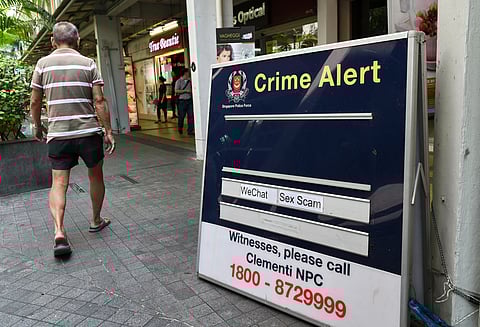 This picture taken February 10, 2017 shows a police crime alert signboard warning against online scams displayed at a public housing estate in Singapore.