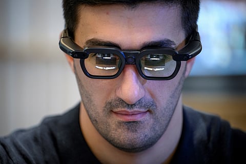 A visitor uses NTT Docomo XR smart glasses at the MWC (Mobile World Congress), the world's biggest mobile fair, in Barcelona on March 4, 2025.
