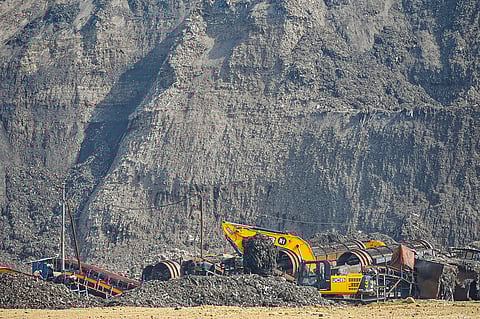 A JCB crane machine clears the garbage at Bhalswa landfill, in New Delhi on Tuesday.