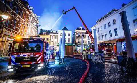 Firefighters work at the site of a large fire in the centre of Arnhem on March 6, 2025.