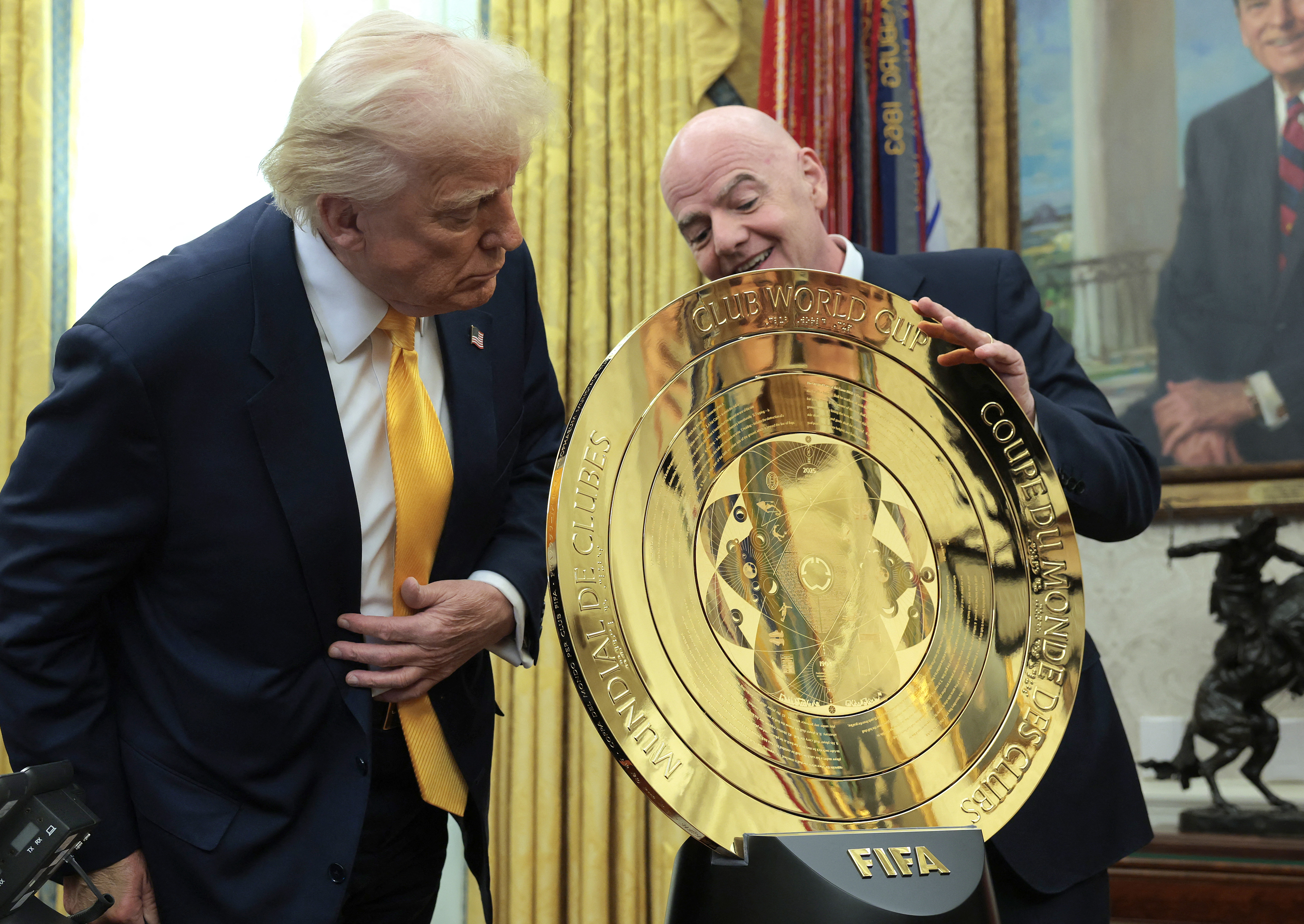 S. President Donald Trump and President of Fédération Internationale de Football Association (FIFA) Gianni Infantino unveil the 2025 Club World Cup trophy in the Oval Office at the White House on March 07, 2025 in Washington, DC. President Trump signed an executive order establishing a White House Task Force for the 2026 World Cup.
