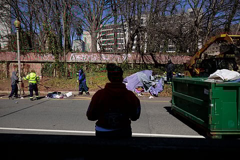 City officials and law enforcement clear out a homeless encampment near the US State Department on March 07, 2025 in Washington, DC.