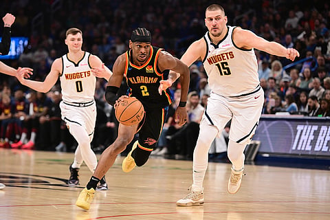 Shai Gilgeous-Alexander #2 of the Oklahoma City Thunder attempts to drive past Nikola Jokic #15 of the Denver Nuggets during the first half at Paycom Center on March 9, 2025 in Oklahoma City, Oklahoma.