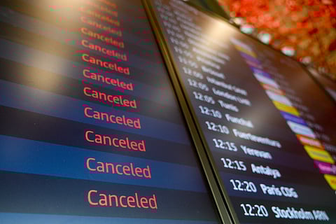A display showing cancelled flight due to a strike of German union Verdi is pictured at the Berlin-Brandenburg Airport (BER) in Schoenefeld, southeast of Berlin, on March 10, 2025.