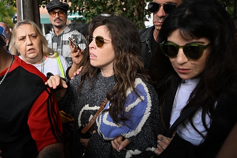 Dalma (C) and Giannina Maradona (R), daughters of late Argentine football legend Diego Maradona, arrive at the San Isidro court ahead of the trial for the death of their father in San Isidro, Buenos Aires province, Argentina on March 11, 2025.