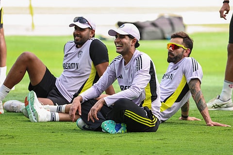India's Shubman Gill (centre), Virat Kohli (right)  and Harshit Rana having a laugh during a practice session ahead of the Champions Trophy final at Dubai International Stadium.
