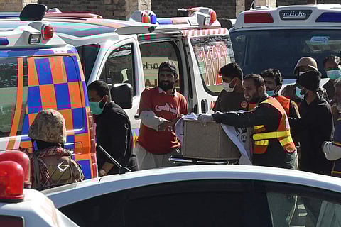 Volunteers carry the coffin of a Pakistan's soldier killed by armed militants who ambushed the train in the remote mountainous area of southwestern Balochistan province, in Mach, on March 13, 2025.