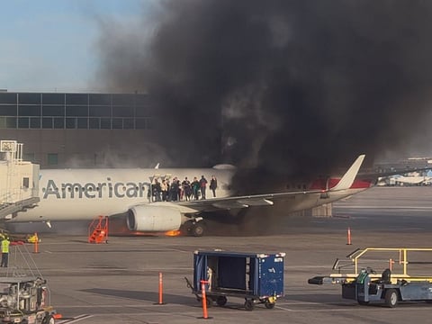 American Airlines plane catches fire at Denver Airport, passengers evacuate onto wing