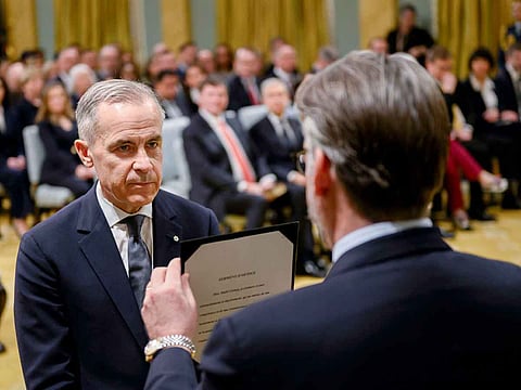 Mark Carney (left)is sworn in as Canada's prime minister during a ceremony at Rideau Hall in Ottawa, Ontario, Canada, on Friday, March 14, 2025.