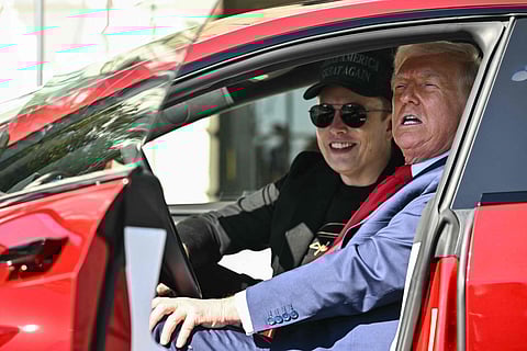 US President Donald Trump and Tesla CEO Elon Musk speak to the press as they sit in a Tesla vehicle on the South Portico of the White House on March 11, 2025 in Washington, DC.