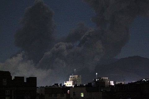 A plume of smoke billows during a US strike on Yemen's Huthi-held capital Sana'a early on March 16, 2025.