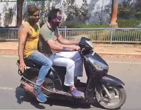 Tej Pratap Yadav riding a scooty without a helmet.
