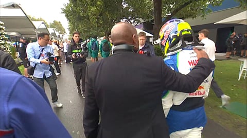 An emotional Hadjar received a hug in the paddock from Lewis Hamilton’s father Anthon