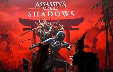 Visitors stand at the 'Assassin's Creed Shadows' video game booth by Ubisoft during the media day at the Gamescom video games trade fair in Cologne, western Germany on August 21, 2024.