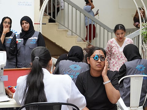 Volunteers of Noor Dubai Foundation and AKCAF Association support residents with free eye screening.