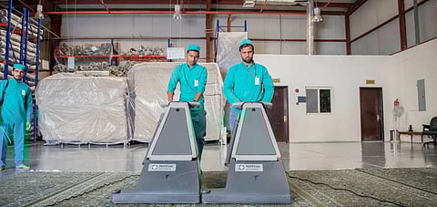 Workers clean and wash Grand Mosque carpets.