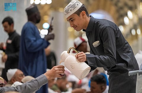 Worshippers are served in the Prophet’s Mosque in Mecca at the Iftar fast-breaking sunset time in the month of Ramadan.