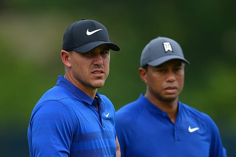 Brooks Koepka (L) and Tiger Woods (R).
