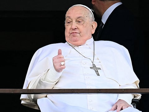 Pope Francis appears at a window of the Gemelli hospital before being discharged following a five weeks hospitalization for pneumonia, in Rome on March 23, 2025