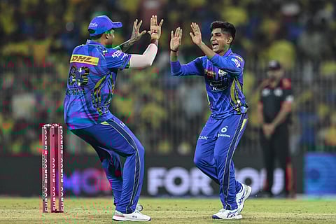 Mumbai Indians' Vignesh Puthur (right) celebrates with his captain Suryakumar Yadav after taking the wicket of Chennai Super Kings' captain Ruturaj Gaikwad during the Indian Premier League (IPL) Twenty20 cricket match at the MA Chidambaram Stadium in Chennai on March 23.