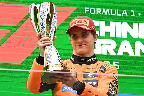 McLaren's Australian driver Oscar Piastri celebrates on the podium with his trophy after winning the Formula One Chinese Grand Prix at the Shanghai International Circuit in Shanghai on March 23.