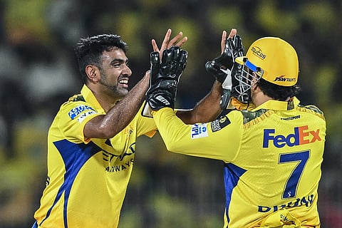 Chennai Super Kings' Ravichandran Ashwin celebrates with his teammate MS Dhoni after taking the wicket of Mumbai Indians' Will Jacks during the Indian Premier League (IPL) Twenty20 cricket match at the MA Chidambaram Stadium in Chennai on March 23.