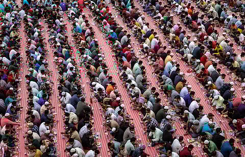 Muslim devotees gather to break their fast during a group iftar at a housing complex for foreign labourers in Dubai on March 28, 2025, during the Muslim holy fasting month of Ramadan.