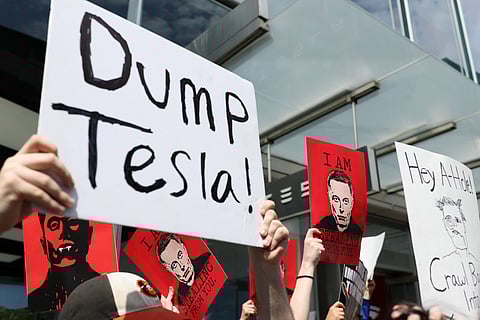 Demonstrators rally against Tesla CEO Elon Musk during a "Tesla Takedown" protest outside a Tesla Store in New York on March 29, 2025.
