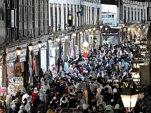 Shoppers browse items along the alley of Damascus' Hamidiya covered market on March 29, 2025, as they prepare for Eid Al Fitr, marking the end of Ramadan.