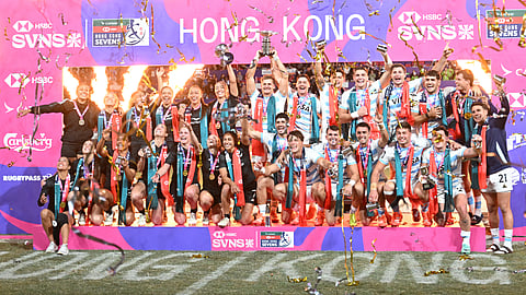 The New Zealand women and Argentina men's teams celebrate with their trophies on the podium after winning their cup finals matches on the third day of the 2025 Rugby Sevens Hong Kong tournament at the Kai Tak sports stadium on March 30.