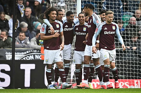 Aston Villa's English striker Marcus Rashford (centre) celebrates with teammates after scoring his team second goal during the English FA Cup quarter-final football match against Preston North End at Deepdale stadium in Preston, north-west England on March 30.