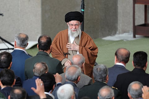 This handout picture provided by the office of Iran's Supreme Leader Ayatollah Ali Khamenei shows him greeting the crowd upon his arrival to lead the morning Eid Al Fitr prayer at the Mosallah in Tehran on March 31, 2025.