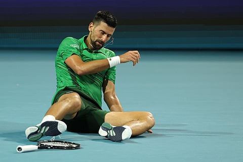 Novak Djokovic of Serbia gets up off the court after losing a point against Jakub Mensik of the Czech Republic.