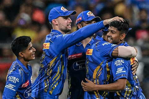 Mumbai Indians' Ashwani Kumar (right) celebrates with teammates after dismissing Kolkata Knight Riders' Andre Russell during their Indian Premier League (IPL) match at the Wankhede Stadium in Mumbai on Monday.
