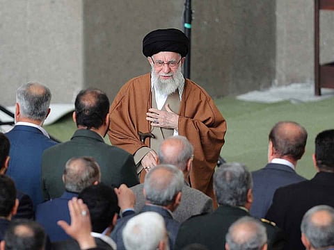 This handout picture provided by the office of Iran's Supreme Leader Ayatollah Ali Khamenei shows him greeting the crowd upon his arrival to lead the morning Eid Al Fitr prayer at the Mosallah in Tehran on March 31, 2025.