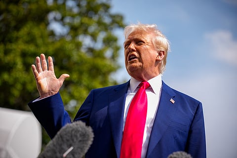 US President Donald Trump speaks to members of the media before boarding Marine One on the South Lawn of the White House.