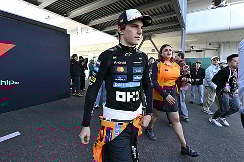 McLaren's Oscar Piastri (L) walks in the paddock after topping the second practice session of the Formula One Japanese Grand Prix at the Suzuka circuit on Friday.