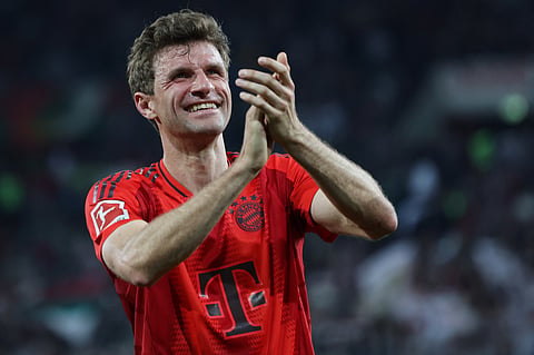 Bayern Munich's Thomas Mueller celebrates after the German first division Bundesliga football match against FC Augsburg in Augsburg, southern Germany, on April 4, 2025.