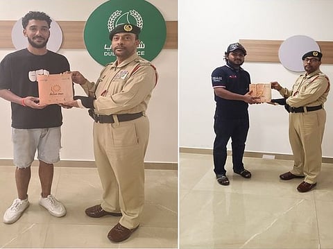 Dubai Police praised two residents for their integrity after returning lost valuables