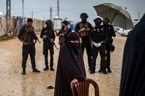 Women and children queue during a joint security operation by Syria's Kurdish Internal Security Police Force, also known as Asayesh, and the Kurdish-led Syrian Democratic Forces (SDF) at Camp Roj where foreign relatives of people suspected of belonging to the Islamic State (IS) group are held, in the countryside near al-Malikiyah (Derik) in the northeastern Syrian Hasakah province on April 5, 2025.