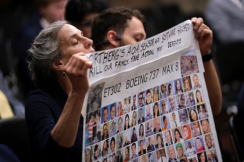 Family members of victims of the Ethiopian Airlines Boeing 737 MAX 8 crash hold a sign as President and CEO of Boeing Kelly Ortberg prepares to testify before the Senate Commerce, Science, and Transportation Committee in the Dirksen Senate Office Building on April 2, 2025 in Washington, DC.