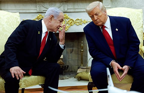 Israeli Prime Minister Benjamin (L) talks to U.S. President Donald Trump during a meeting in the Oval Office of the White House on April 7, 2025 in Washington, DC.