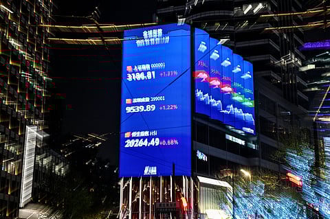 A screen showing the Shanghai composite index (top), Shenzhen component index (C) and Hang Seng Index (bottom) is seen in Jing'an district in Shanghai on April 9, 2025.