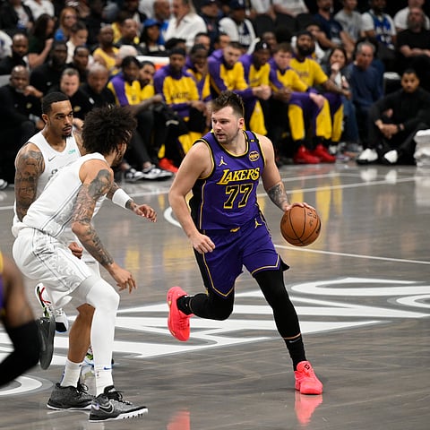 Luka Doncic is pressured by his former team-mates as he dribbles the ball during the game against the Dallas Mavericks, his former team, on April 9, 2025, at American Airlines Center in Dallas, Texas.
